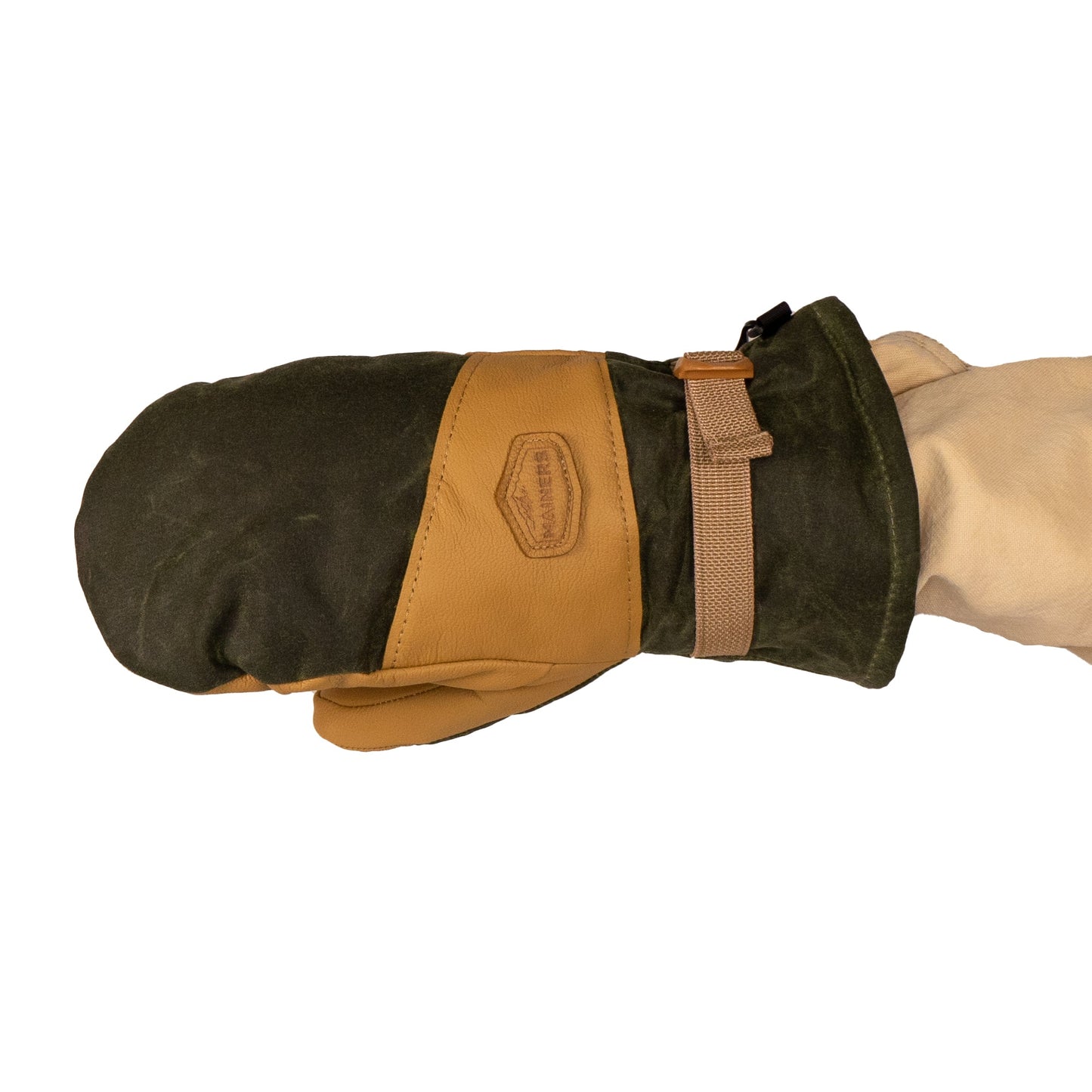 A person wearing a beige sleeve holds the green and tan leather Acadia Mitts by Mainers, complete with a strap, ensuring both warmth and comfort.