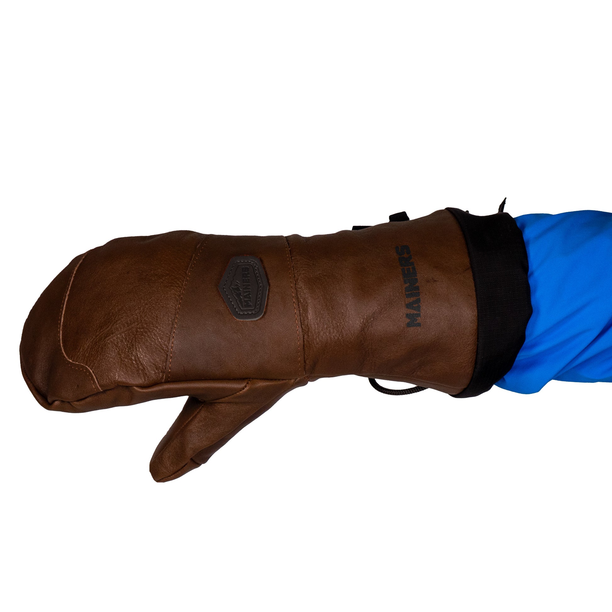 A brown all-leather mitten from Mainers, recognized for its exceptional wind resistance, worn by a person in a blue sleeve, against a plain white background.
