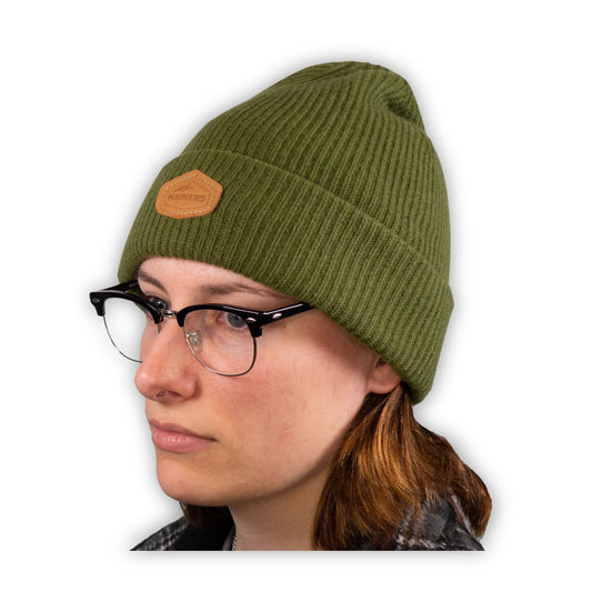A woman wearing glasses and a Mainers Cashmere Beanie.