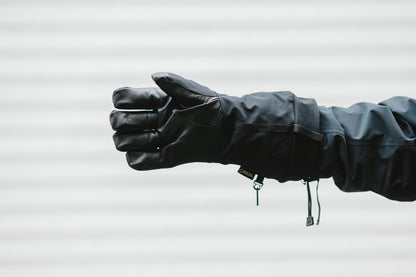 A person wearing a pair of Mainers Rangeley Gloves holding a fist.