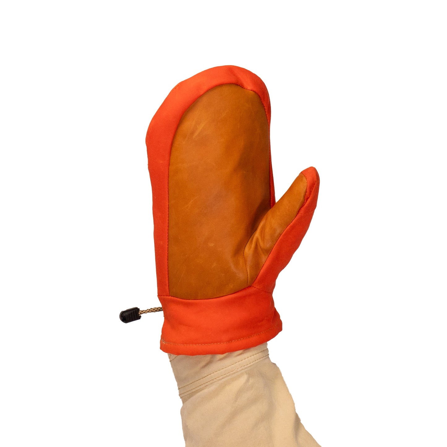 A hand wearing a Mainers Portland Mitts, featuring a leather palm and red fabric sides, is held upright against a white background.