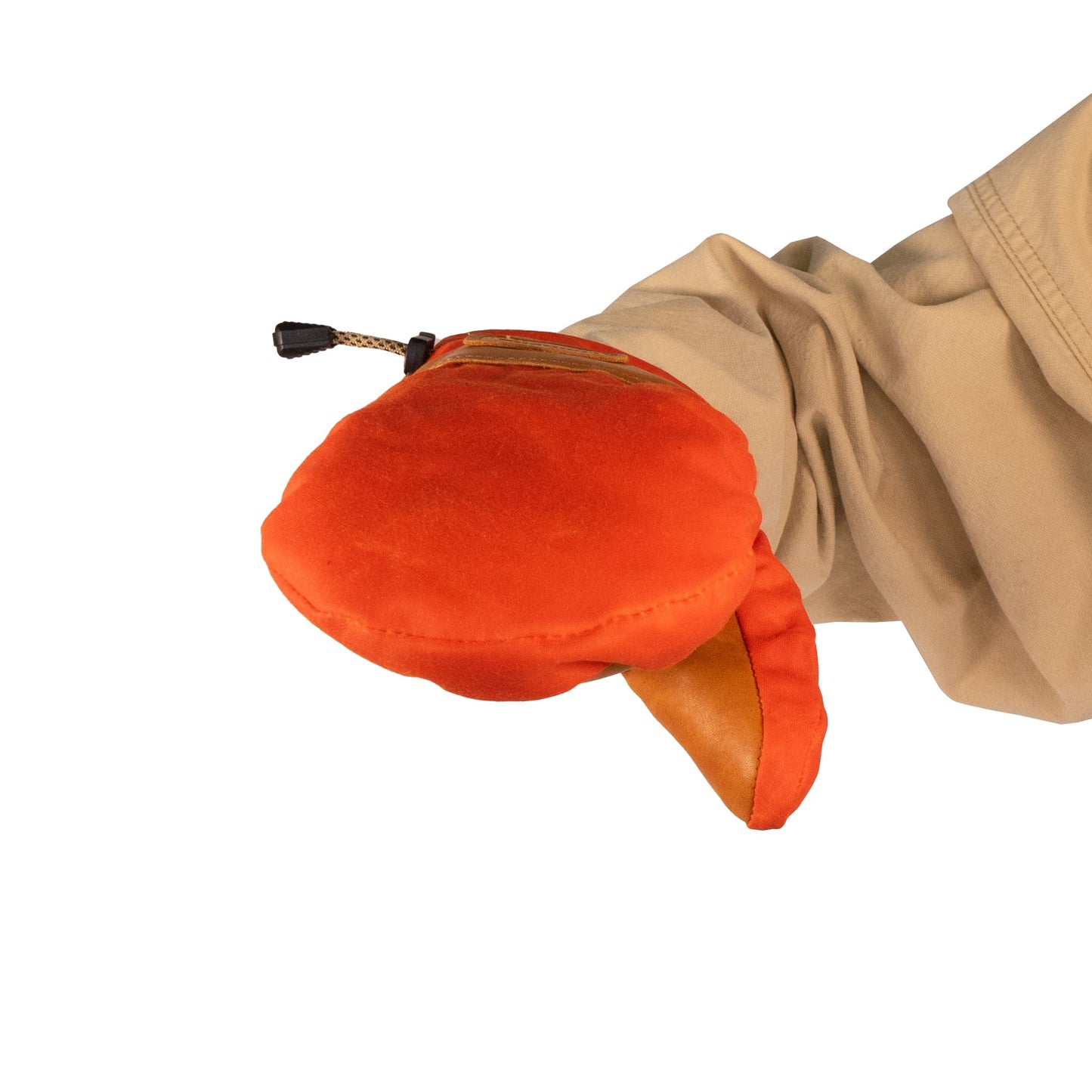 A person in a beige jacket holds a Portland Mitt by Mainers, an orange oven mitt featuring an open mouth design and crafted with a durable leather palm.
