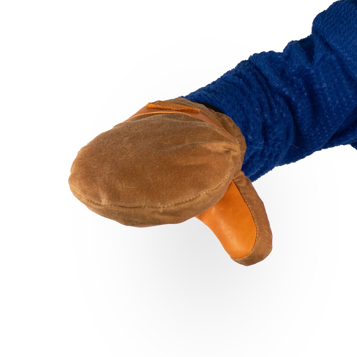 A person wearing a blue jacket holds out their hand, protected by a durable Mainers Peaks Mitts, highlighting its toughness during an outdoor adventure.