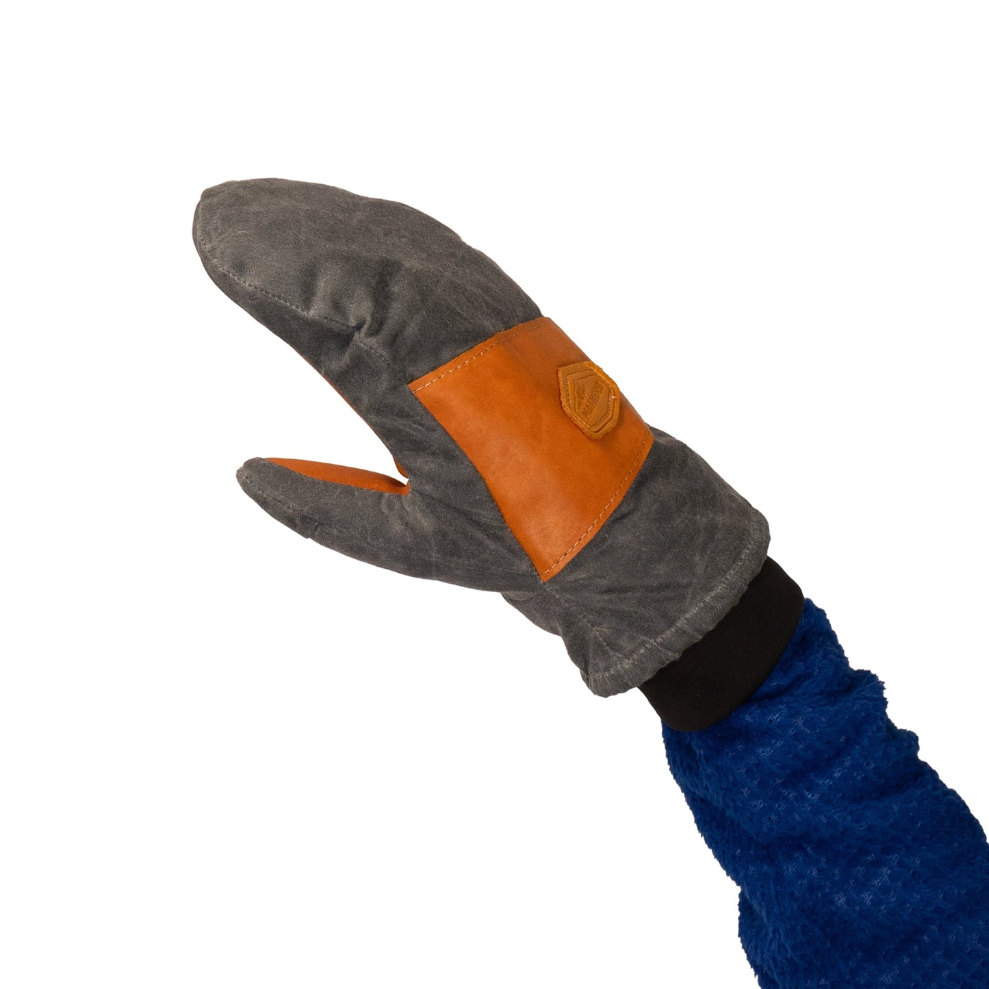 A blue-sleeved arm displays a gray and brown Peaks Mitt from Mainers, highlighting its rugged durability that's ideal for any outdoor adventure.