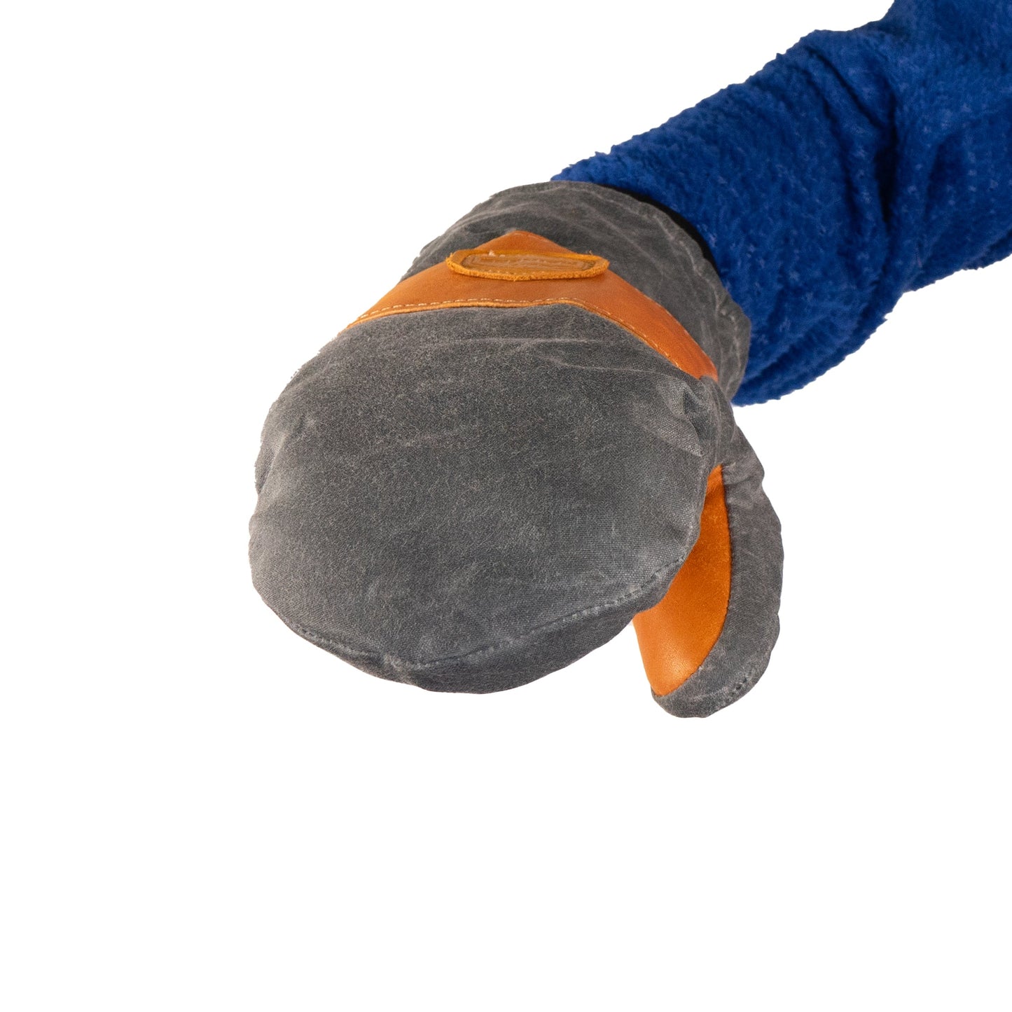 A blue-sleeved arm wearing a gray and brown Peaks Mitts by Mainers is extended forward, showcasing its rugged durability ideal for outdoor adventure.