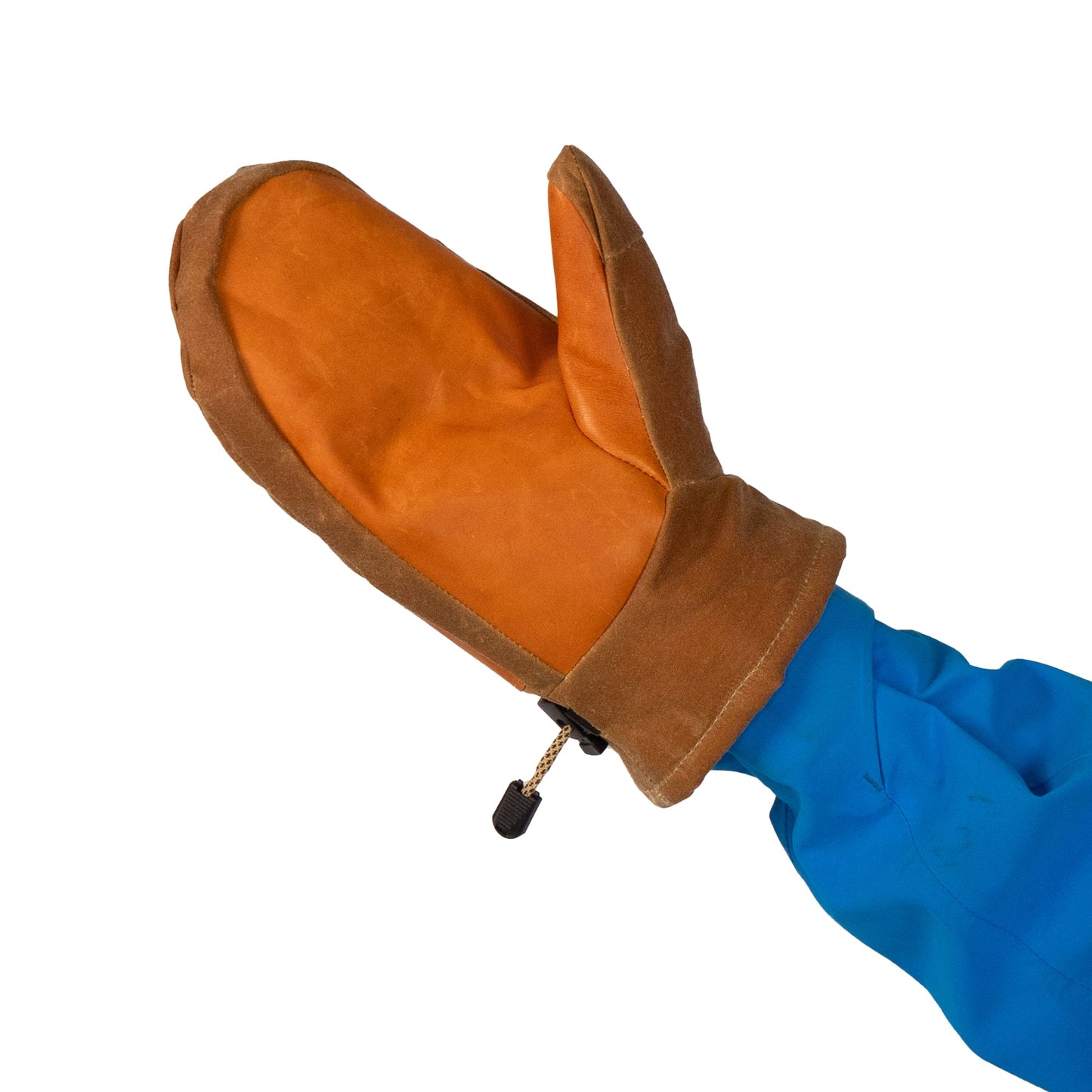 A person wearing a blue jacket is sporting a Mainers Portland Mitt with a prominent brown leather palm on one hand.