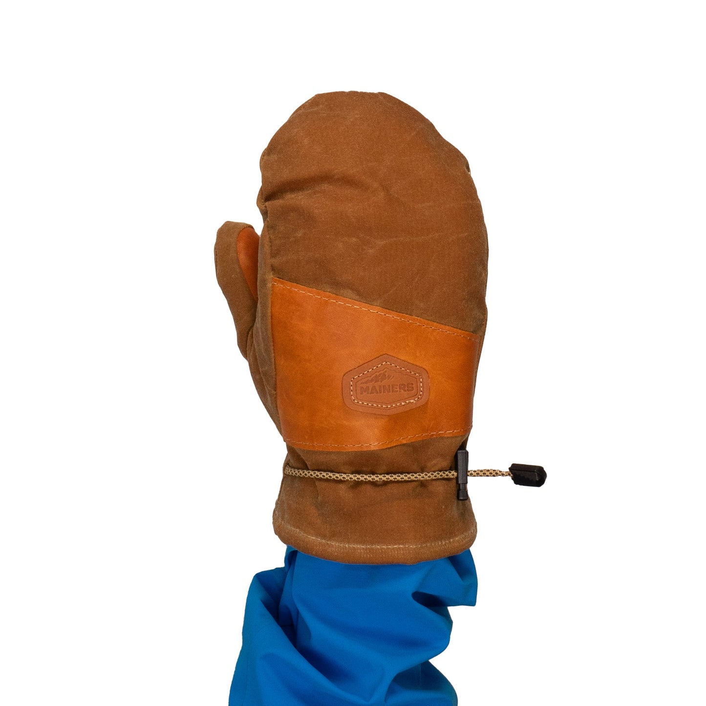 A person in a blue jacket is wearing the Portland Mitts from Mainers, featuring a leather palm and fabric construction.