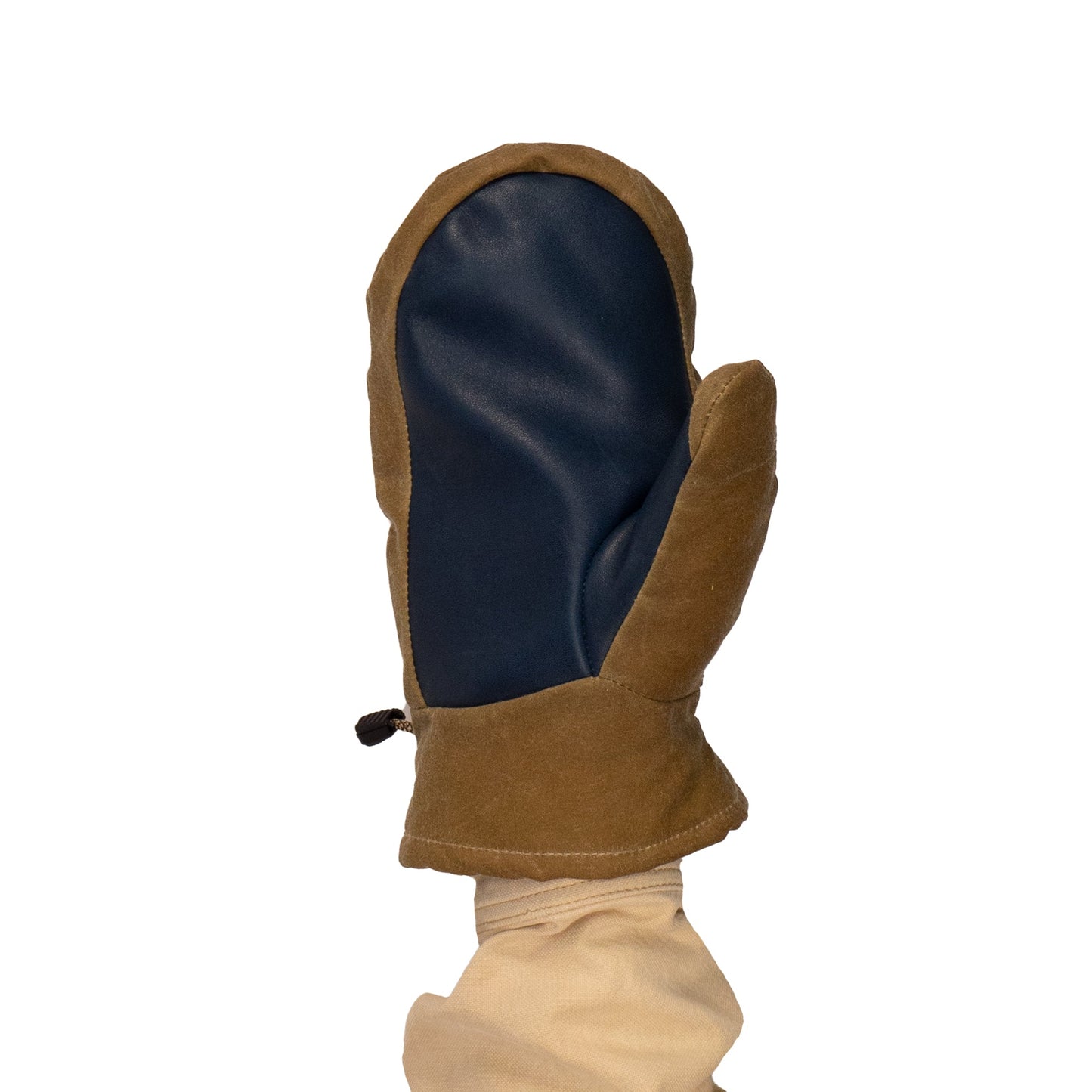 A person wearing a brown and navy blue Mainers' Portland Mitts with a waxed canvas finish holds their hand up against a white background.