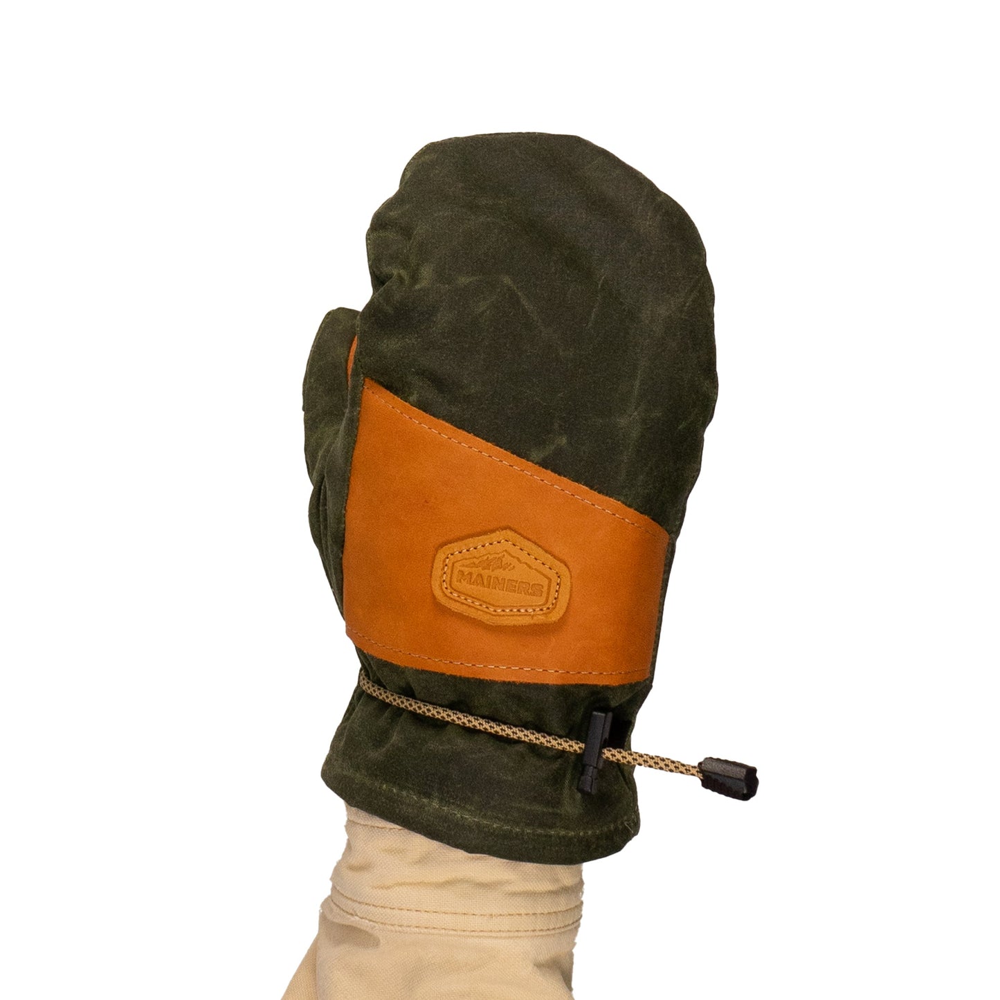 A green Mainers Portland Mitt, featuring a tan leather patch and drawstring cuff in a waxed canvas design, is modeled against a plain background.