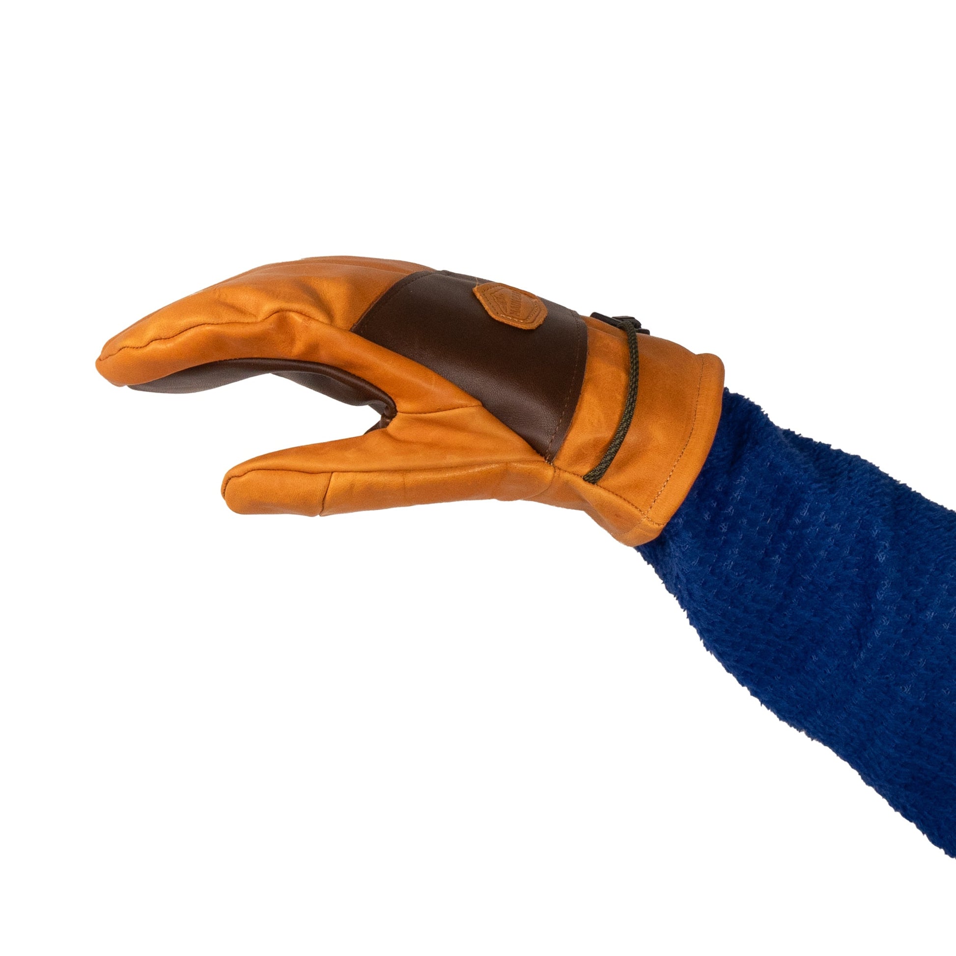A gloved hand wearing a Mainers Portland All-Leather Mitt, featuring exquisite Maine craftsmanship in orange and brown leather with a blue sleeve, is positioned as if about to grasp something.