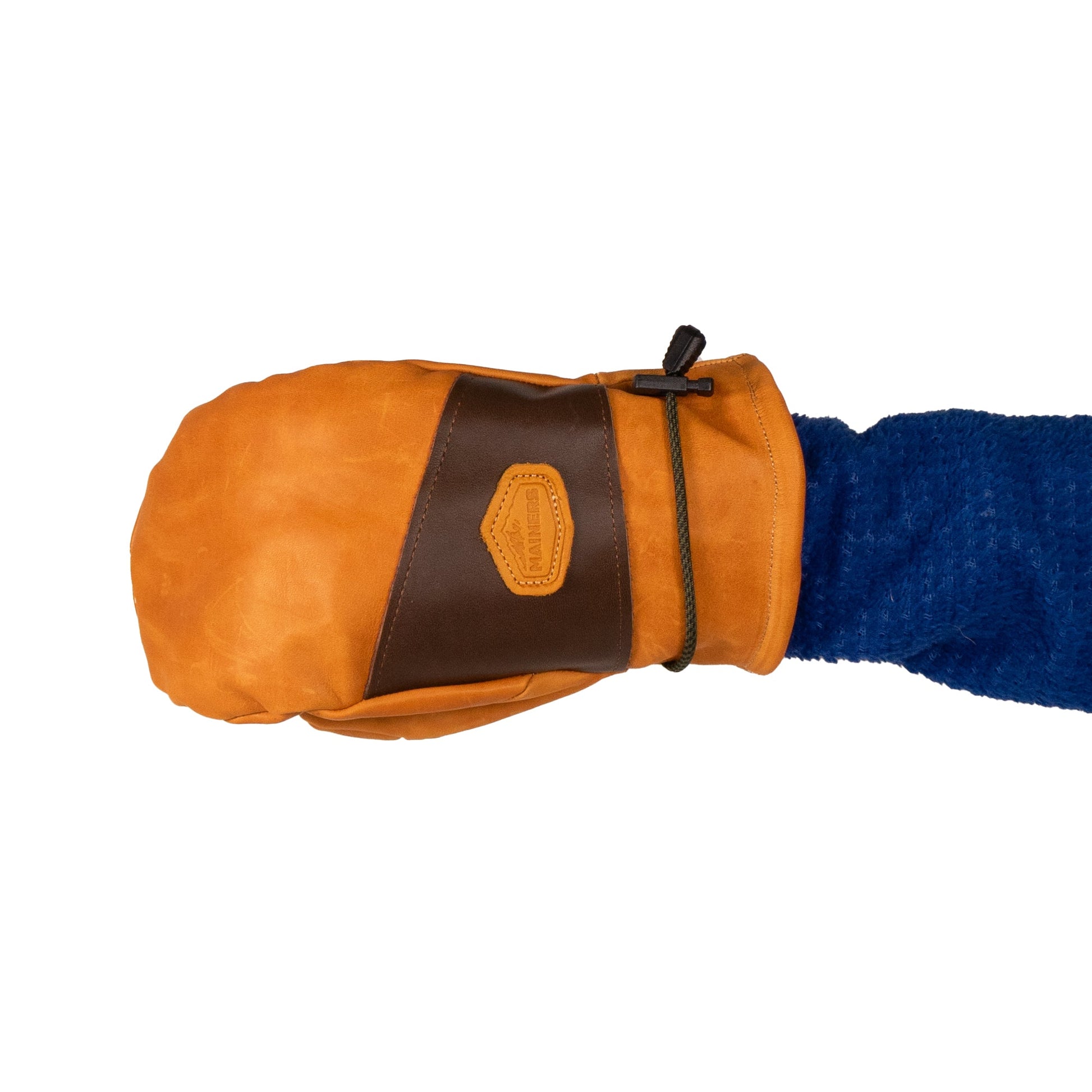 A person wearing a blue sleeve is holding a pair of Portland All-Leather Mitts by Mainers, showcasing Maine craftsmanship with an orange and brown design and a distinctive leather patch.