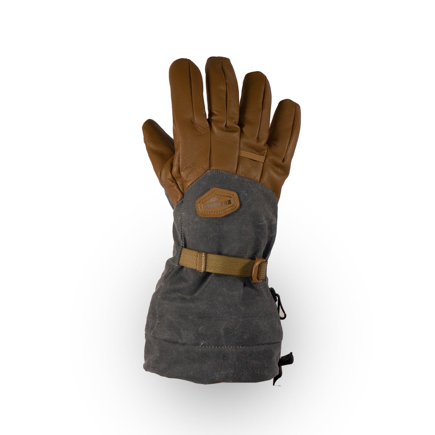 The Bethel Glove by Mainers is a single insulated glove in brown and gray, designed for cold weather adventures. It features a strap and patch on the back, while its waxed canvas construction boosts outdoor performance, guaranteeing warmth and durability in harsh conditions.
