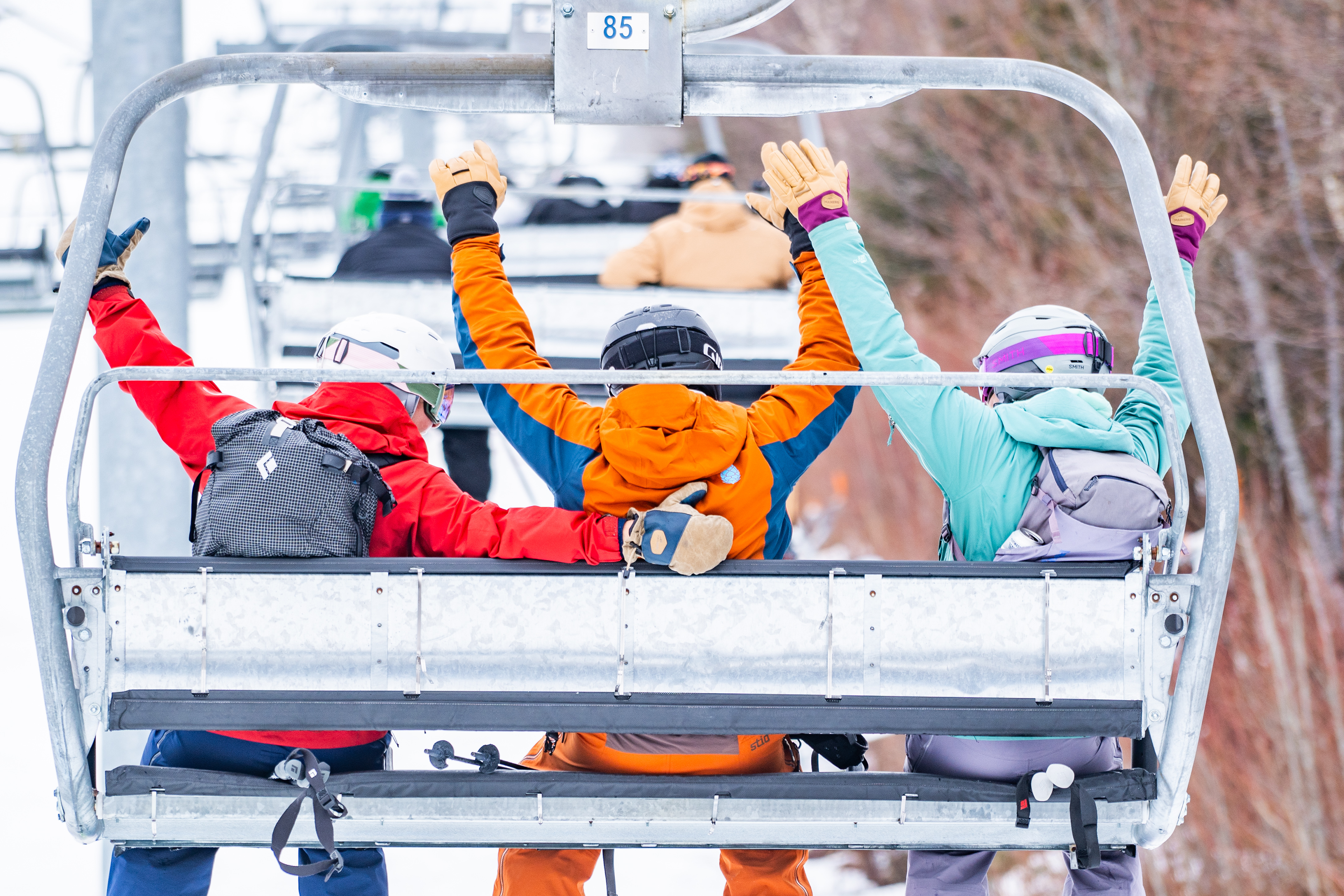 People on a ski lift with colorful winter clothing