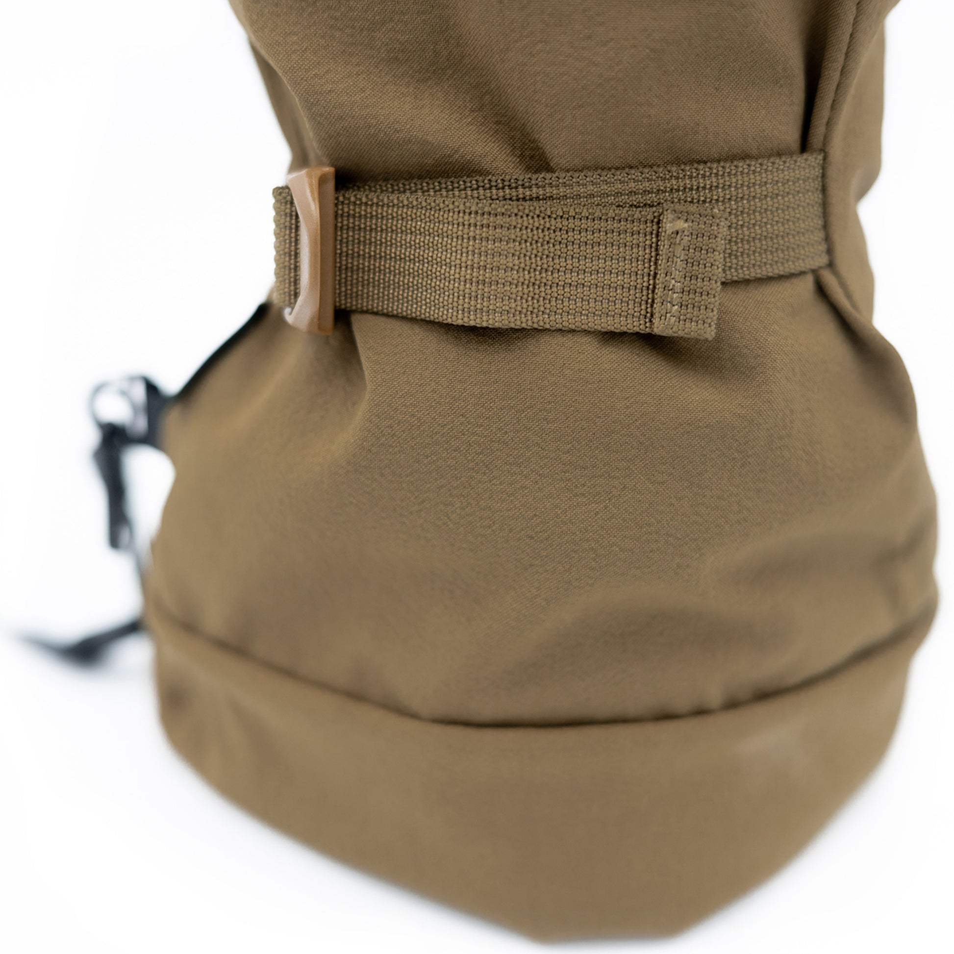 The back of a brown Mainers backpack with a strap.