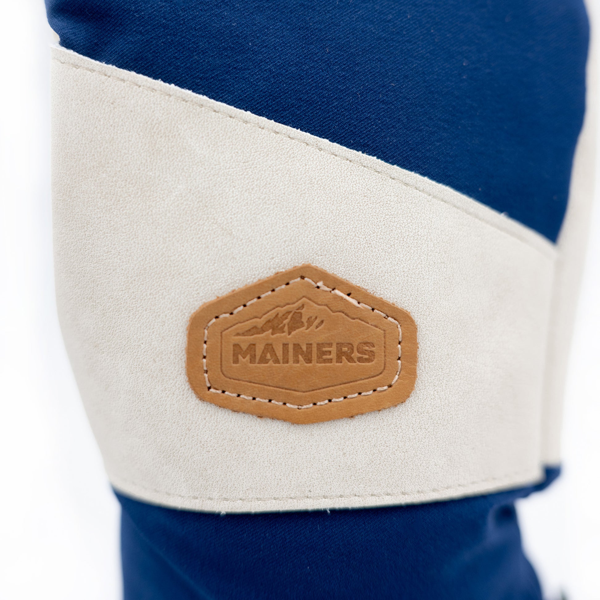 A pair of blue and tan Mainers Mitts featuring the Mainers logo, designed for enhanced resistance and durability.