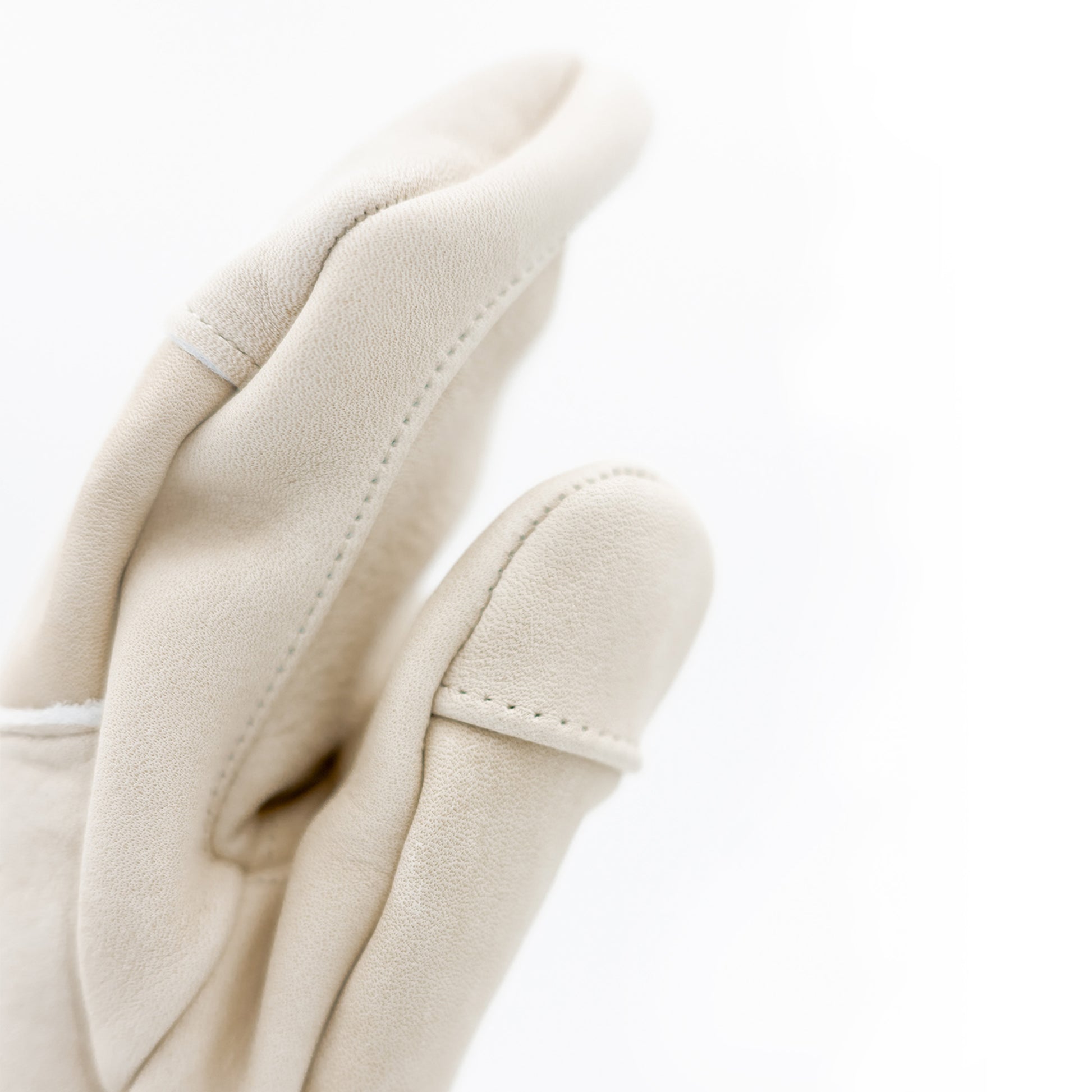 A pair of white leather Mainers Caribou Mitts on a white background, embodying Maine's spirit.