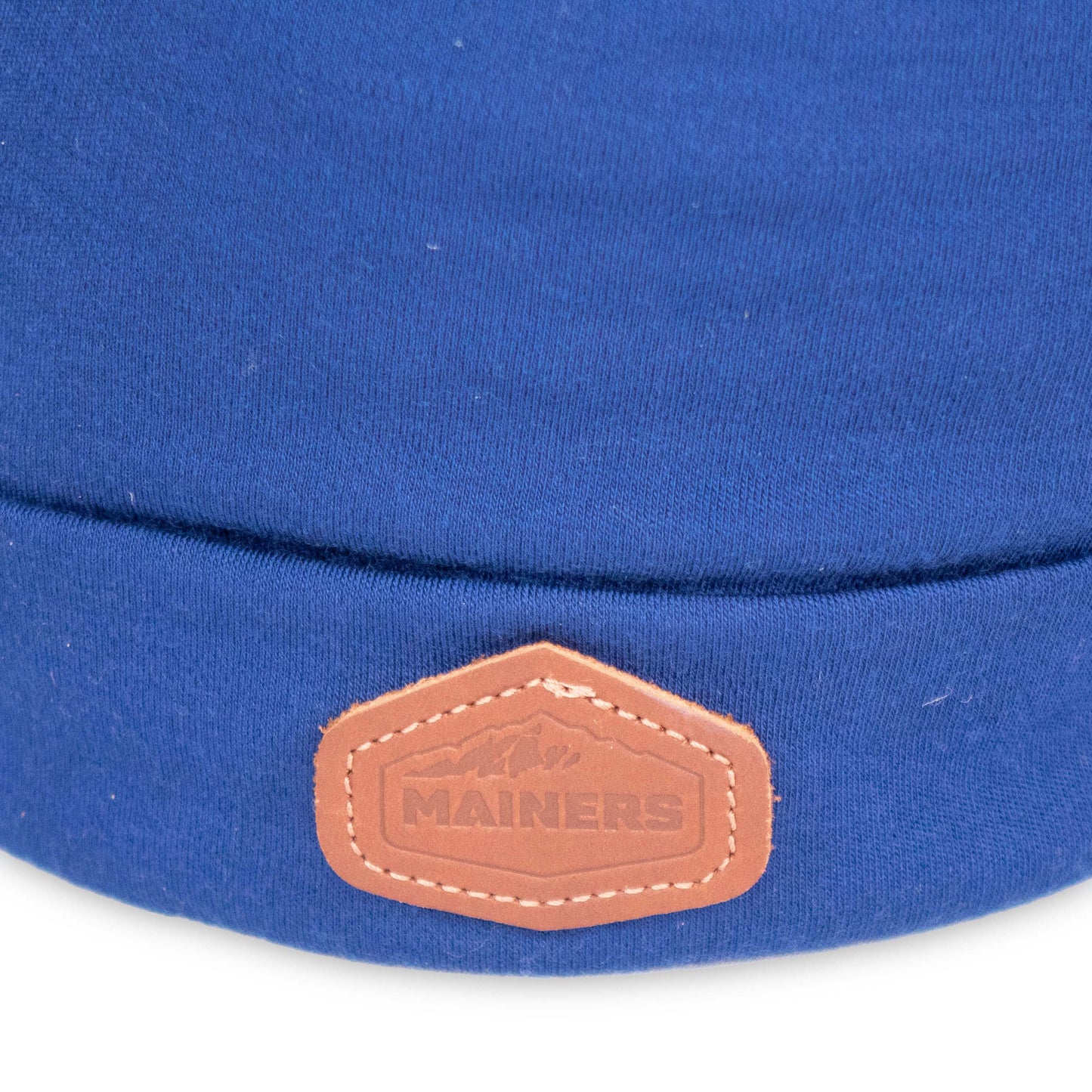 A Mainers Lightweight Wool Beanie with a leather label on it.