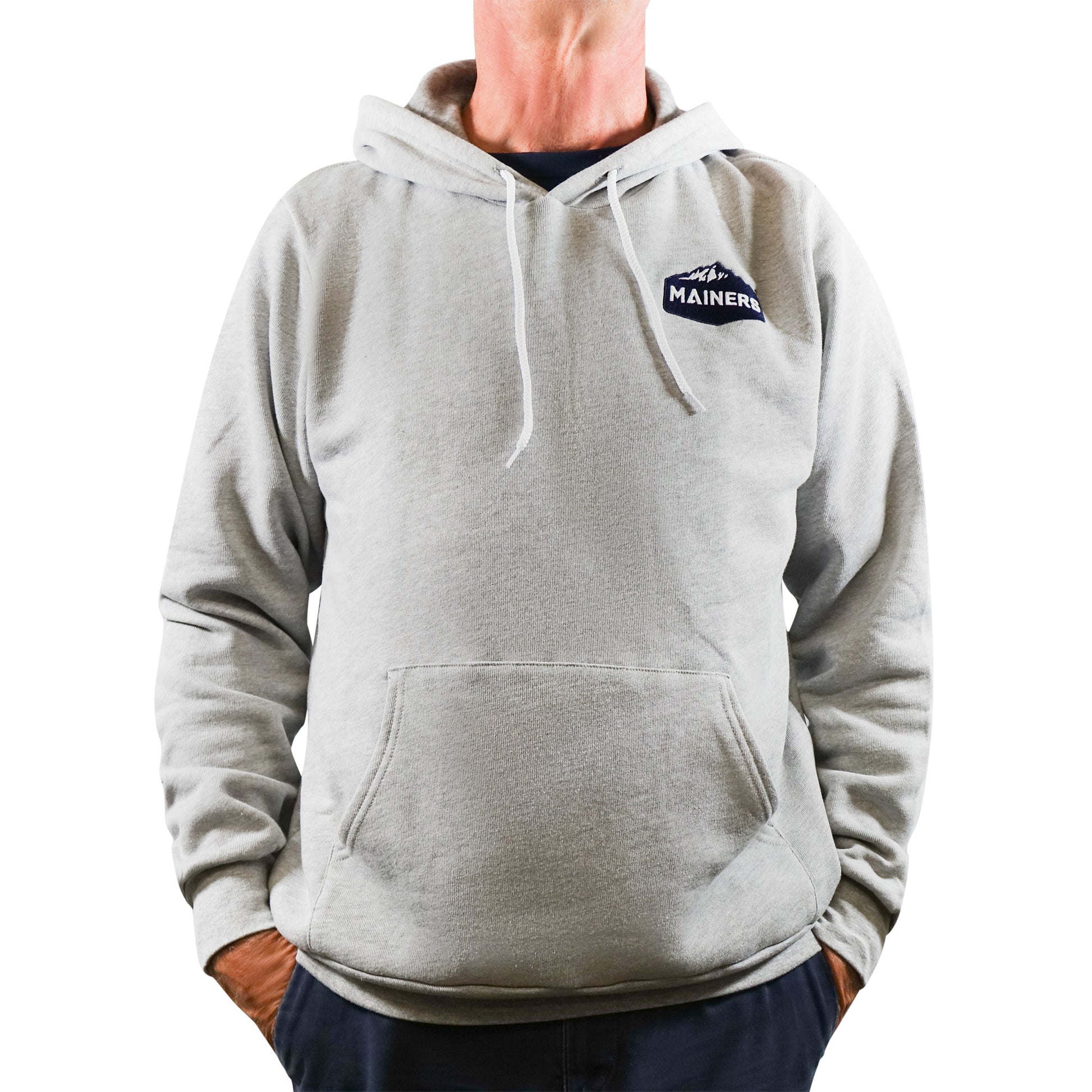 A man in a soft, grey Mainers Hoodie by Mainers.