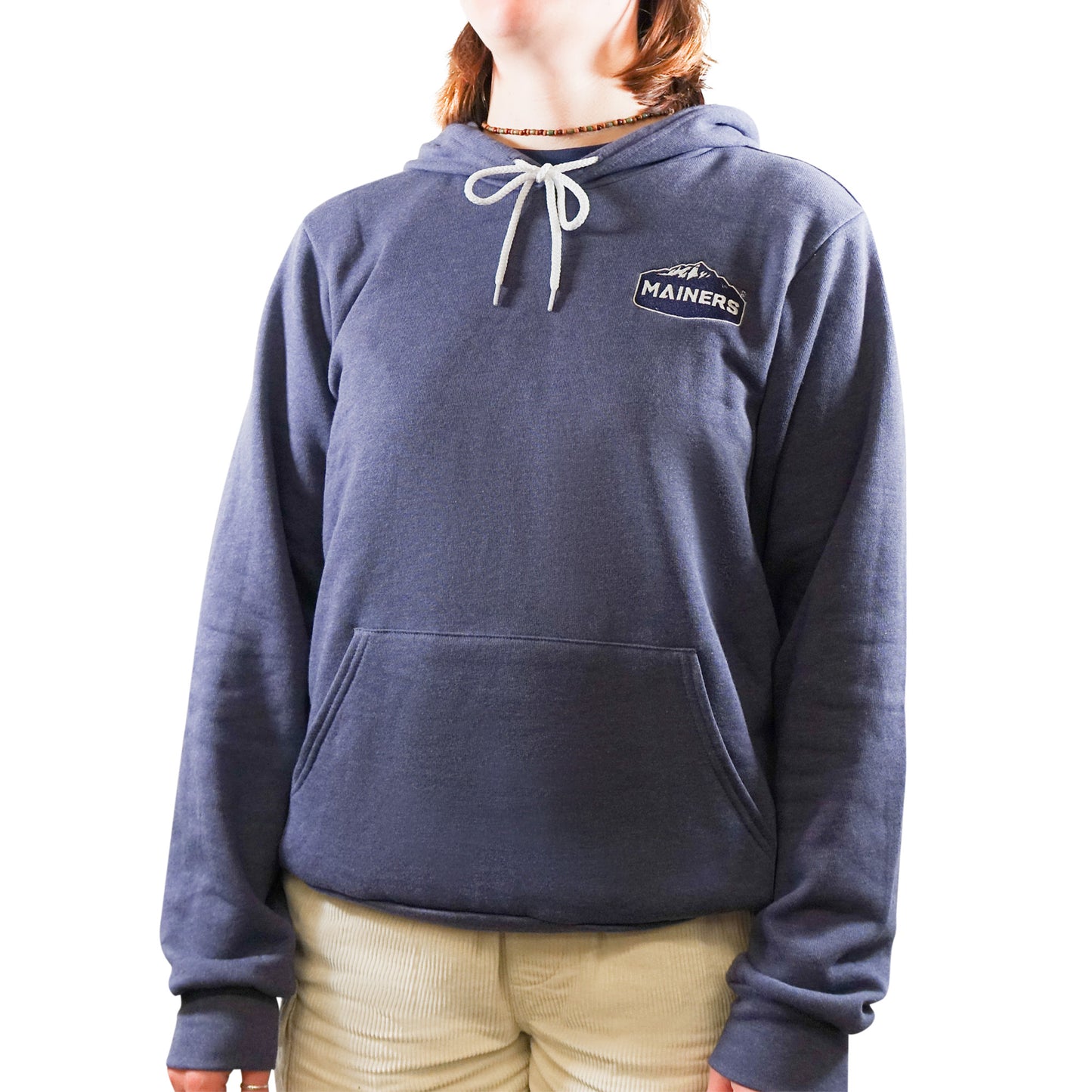 A woman wearing a Mainers pullover hoodie in soft blue.