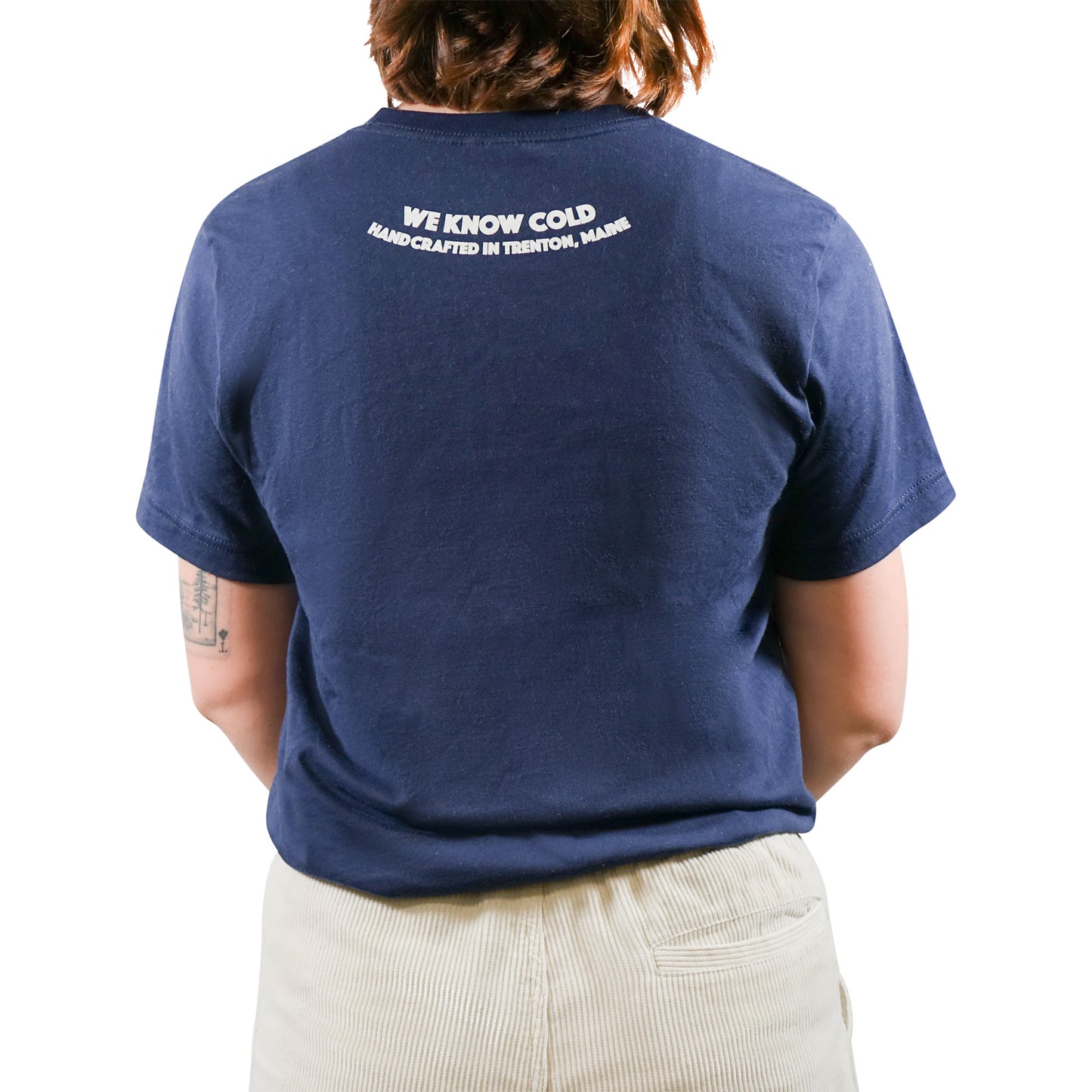The back of a woman wearing a Mainers Cotton Tee that says god works.