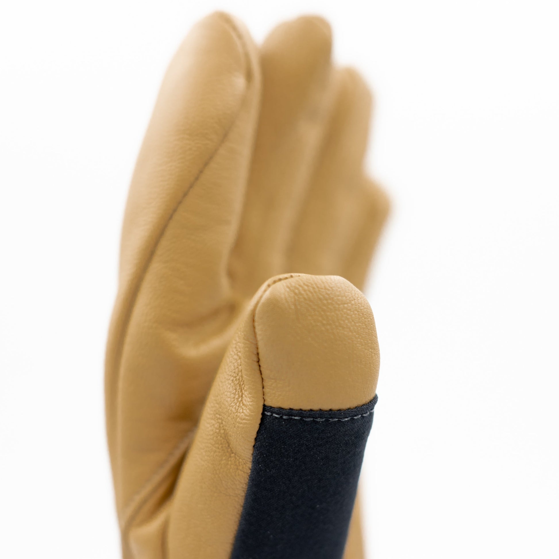 A pair of tan Mainers Rangeley Gloves on a white background.