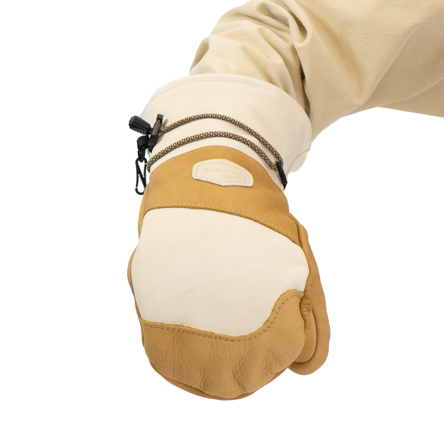 Beige and brown mitten worn by a person on a white background