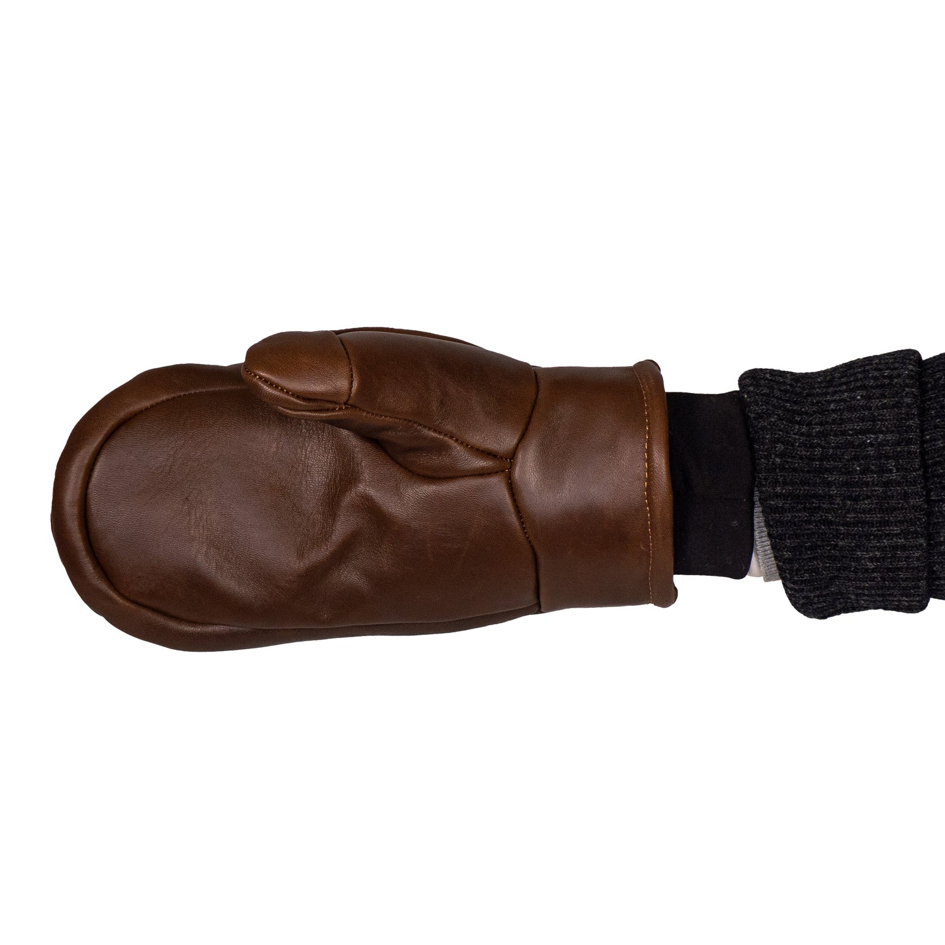 A person wearing the Mainers Peaks All-Leather Mitts with a black knitted cuff stands against a plain white background, embodying the perfect companion for cold-weather excursions.