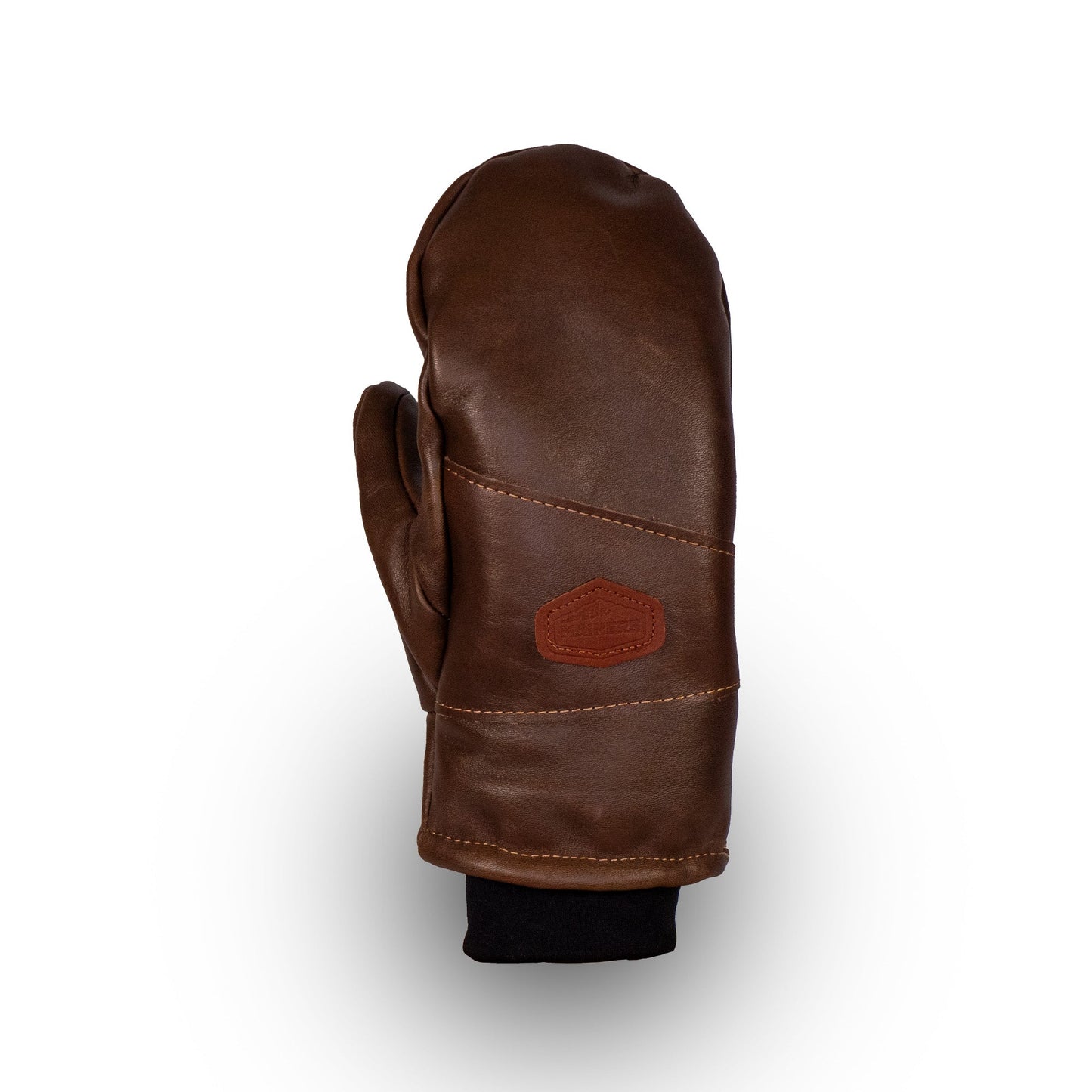 The Peaks All-Leather Mitts by Mainers are crafted from premium leather and feature a discreet stitched logo on the back with a black cuff. Ideal for cold-weather adventures, the mitts stand out beautifully against a pristine white background.