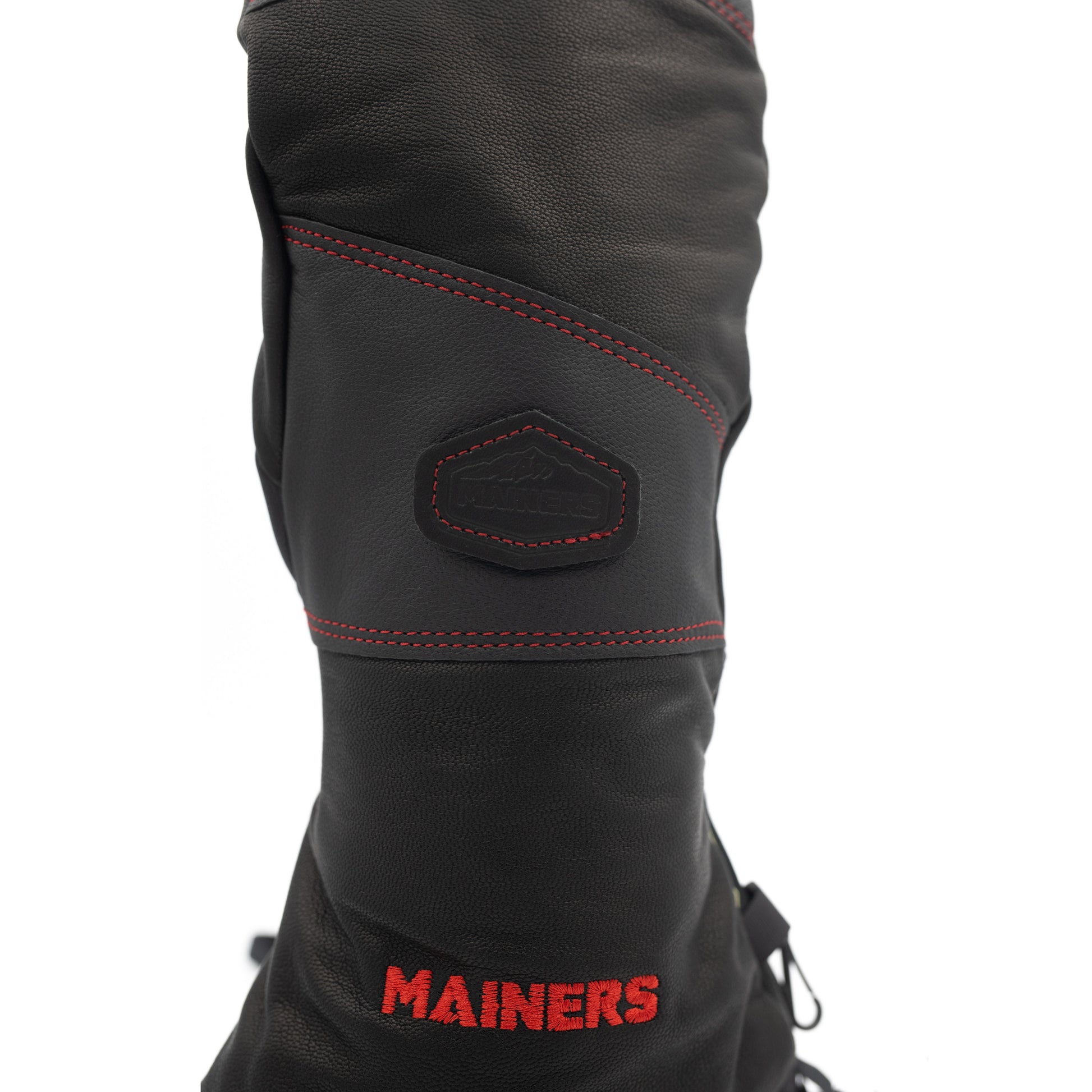 A pair of cold-weather black leather Mainers boots with red stitching.